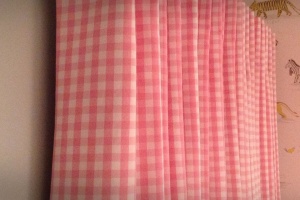 Single pleat pink gingham curtains.